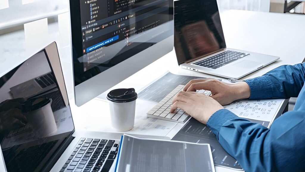 professional website development and a Mac and laptop place on a white table