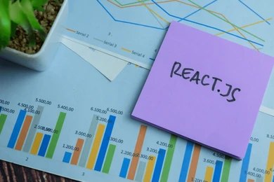 React.js sticky note on business analytics charts and graphs representing web development data