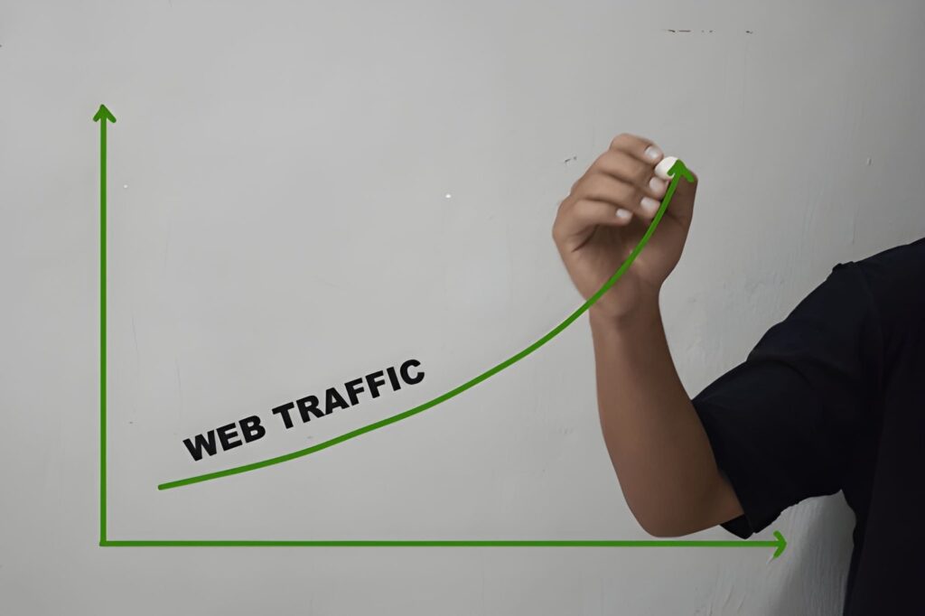 Hand drawing an upward web traffic growth curve on whiteboard representing SEO and organic traffic growth