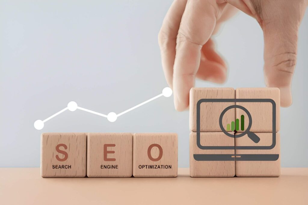 SEO wooden blocks with laptop icon and upward growth chart representing search engine optimization