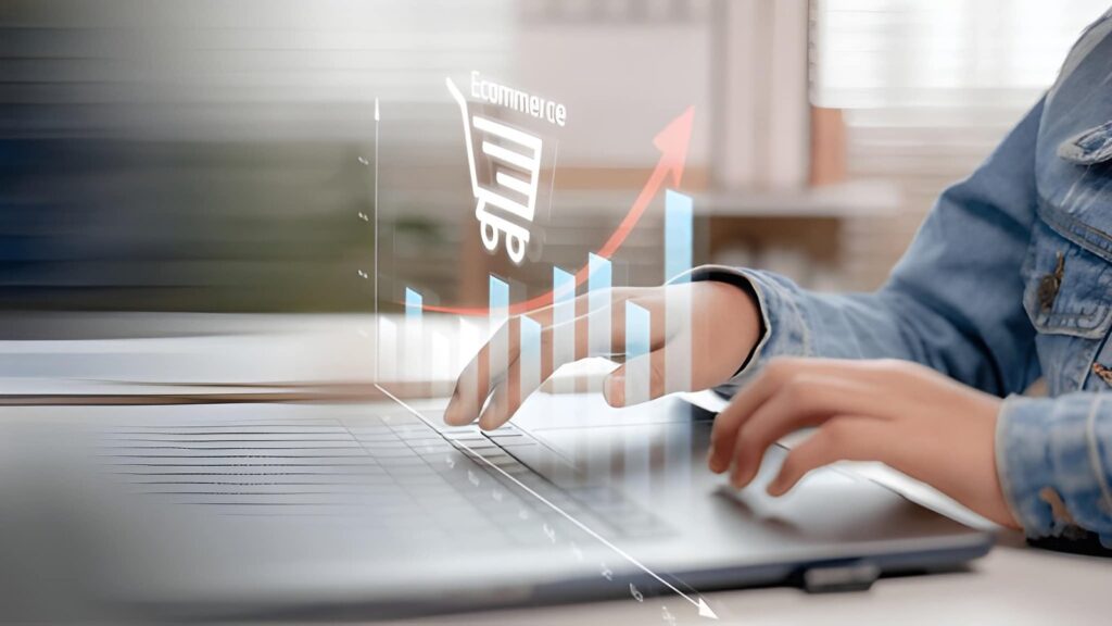 Person typing on laptop with eCommerce sales growth chart and shopping cart icon overlay