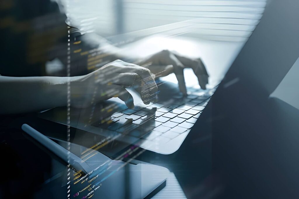 Developer typing on laptop keyboard with overlaid code representing full stack web development