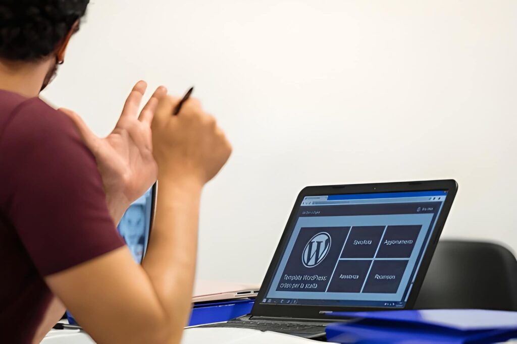 Developer reviewing WordPress dashboard on laptop while planning custom theme development