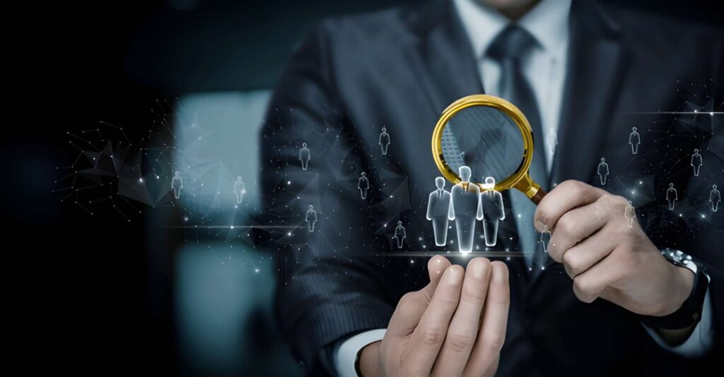 Businessman using magnifying glass to select the right candidate from digital network representing agency hiring process